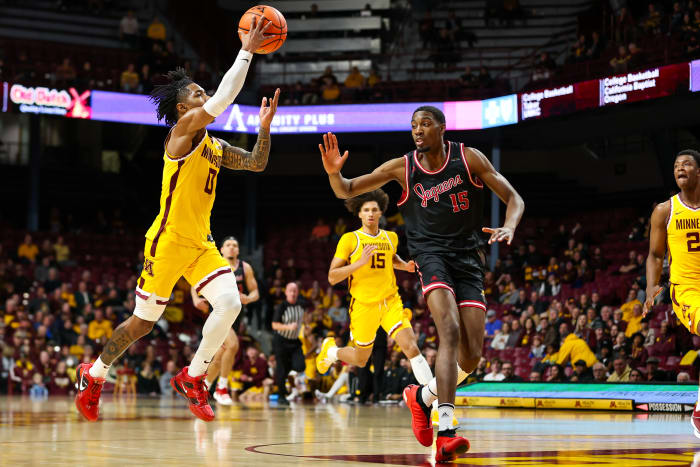 Dec 12, 2023; Minneapolis, Minnesota, USA; Minnesota Golden Gophers guard Elijah Hawkins (0) shoots as IUPUI Jaguars center Yves Nkomba (15) defends during the first half at Williams Arena.